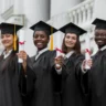 smart-ways-to-spend-your-graduation-money-four-graduates-with-scrolls