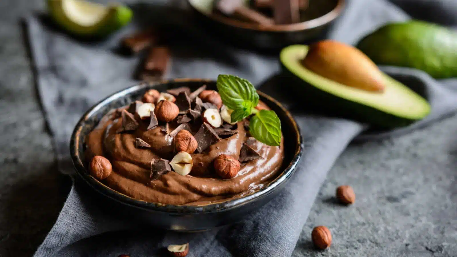 Raw avocado chocolate mousse topped with hazelnuts