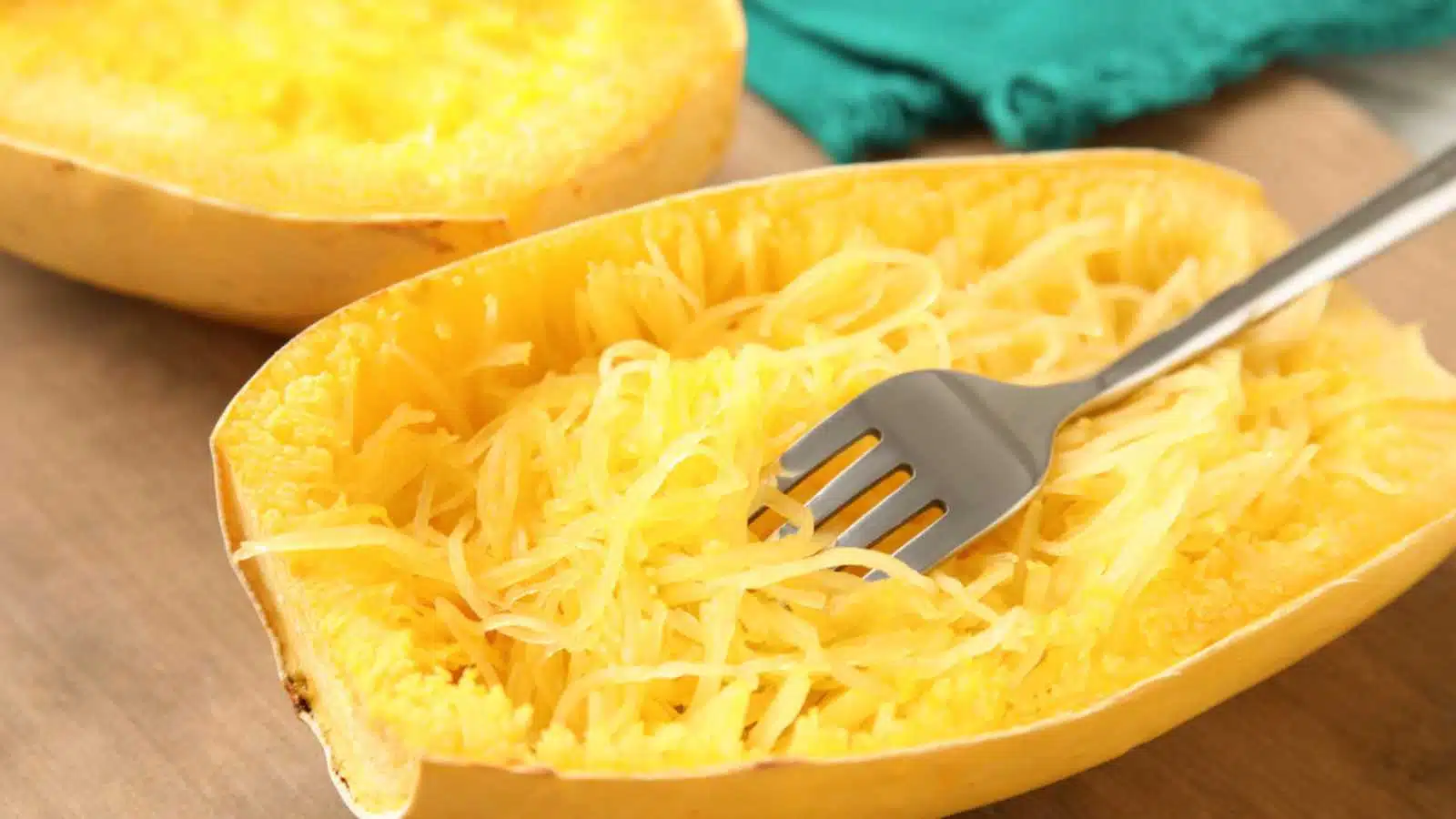 Cooked spaghetti squash and fork on table