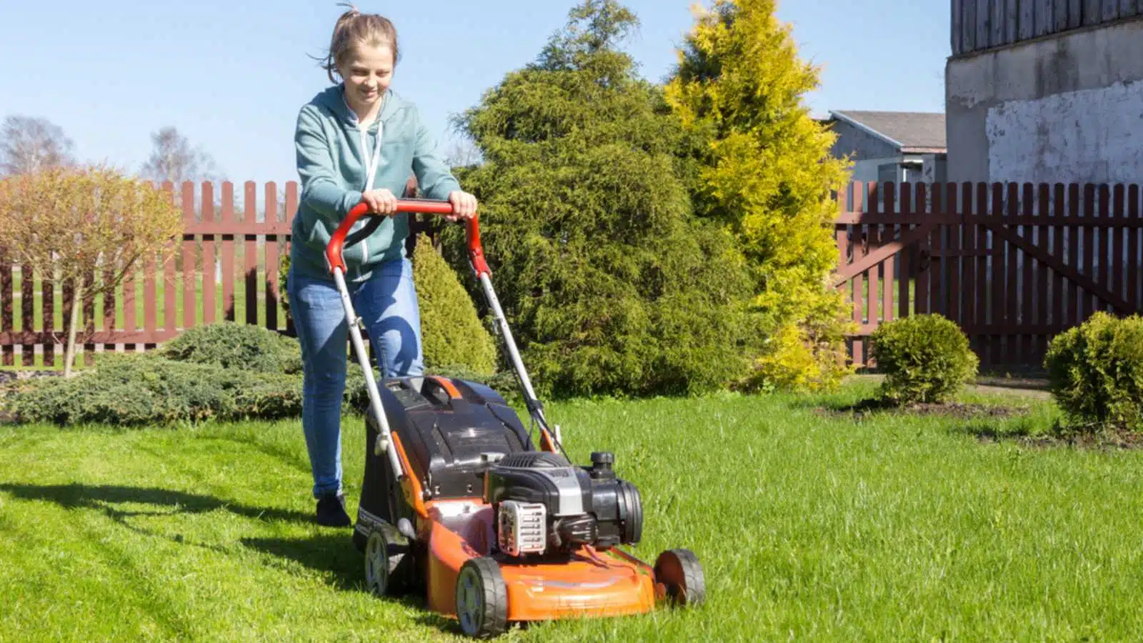 Woman Mowing the Lawn