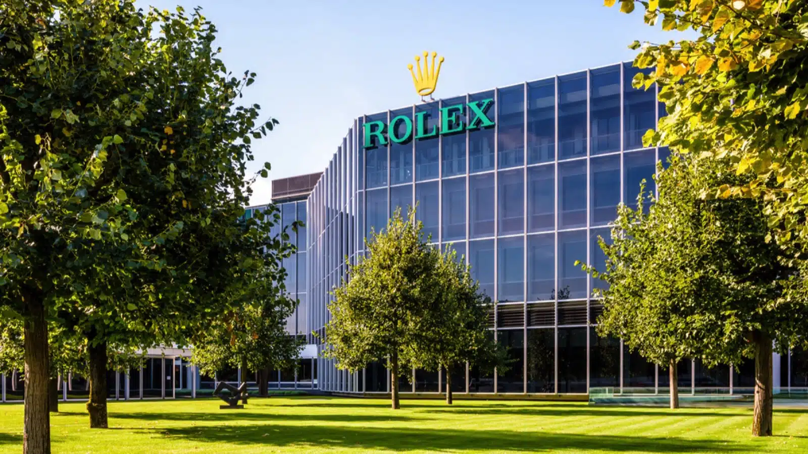 Geneva, Switzerland - September 10, 2020: Glass facade of the headquarters of Rolex, the swiss brand of luxury watches, on a sunny summer morning.