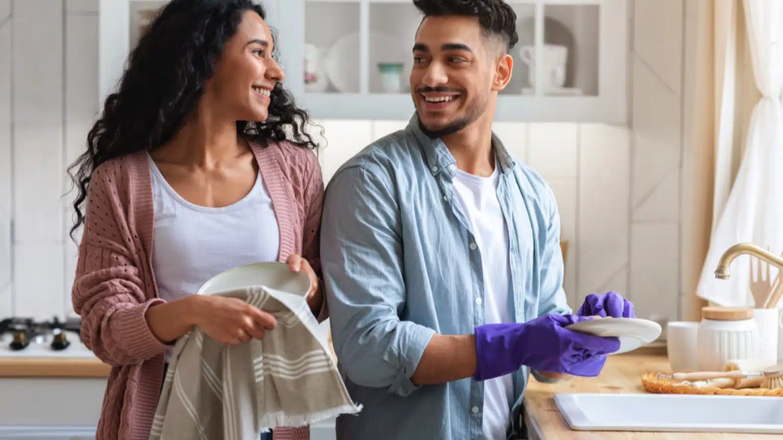 Couples cleaning kitchen