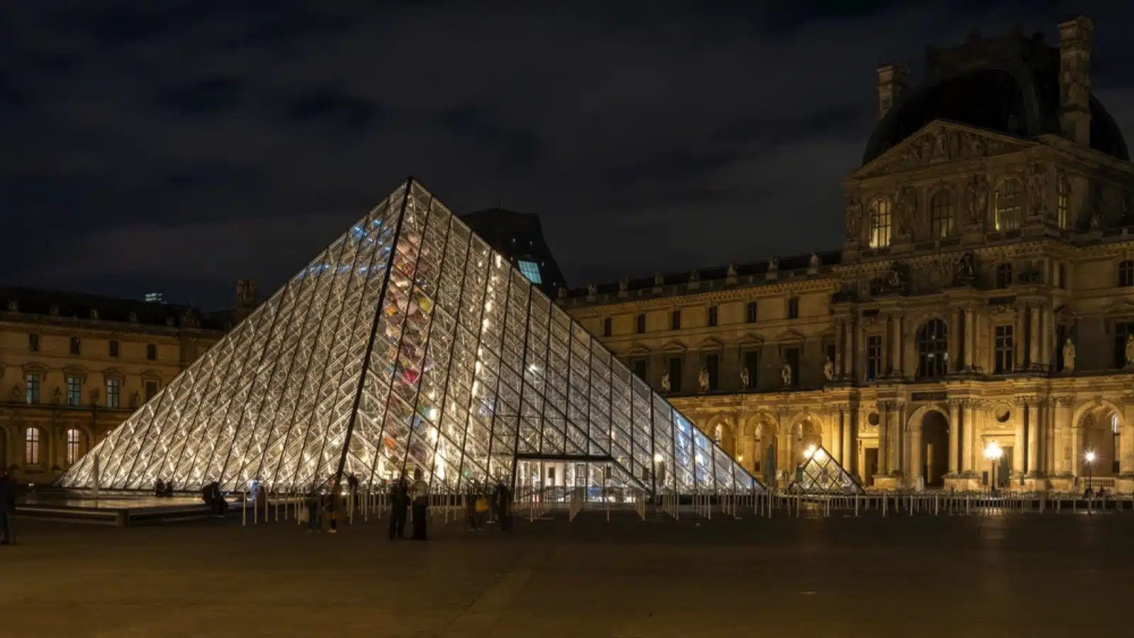 Paris, France - Sep 25 2022; The Louvre glass pyramid illuminated at night