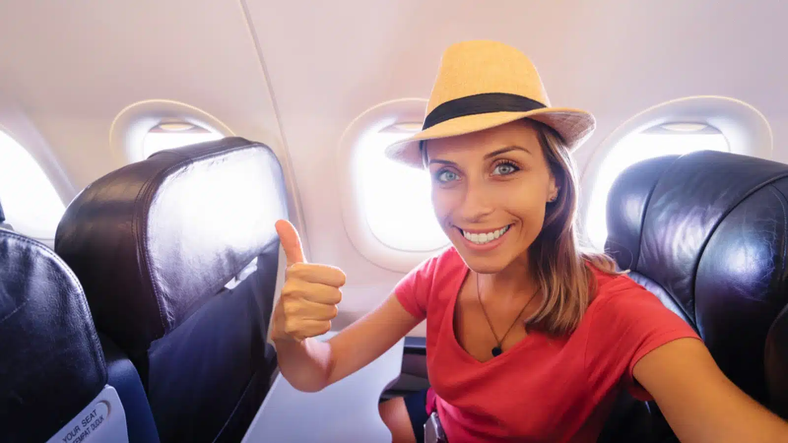Woman taking selfie inside flight