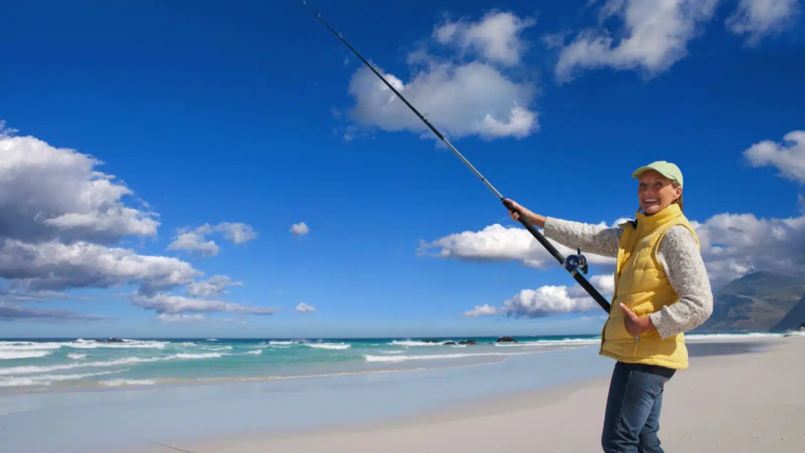 Woman fishing in beach
