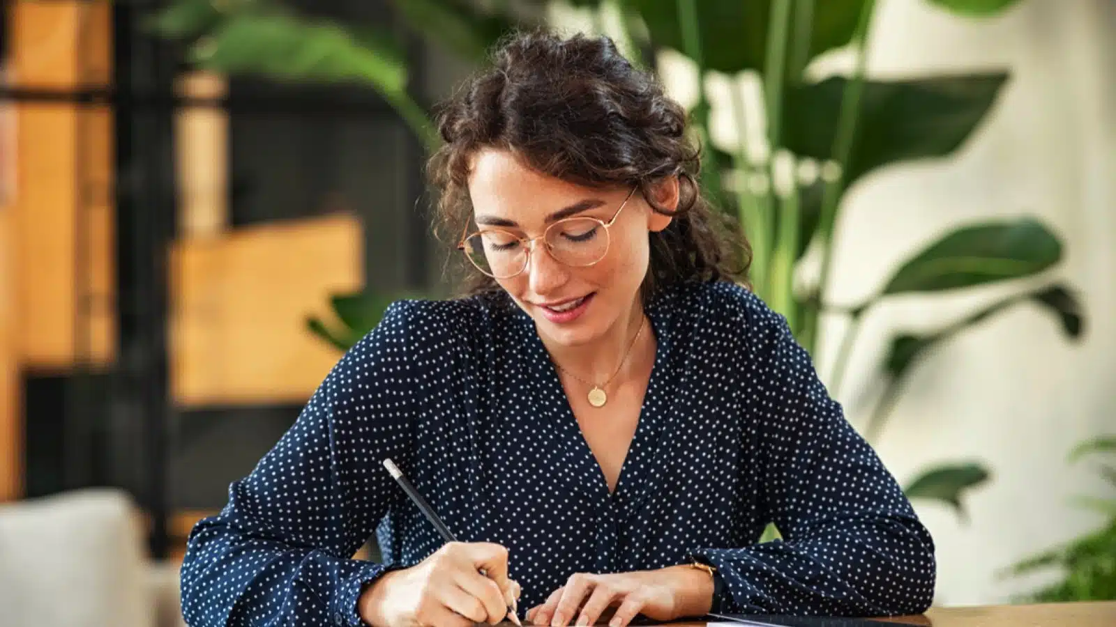 Happy woman writing journal