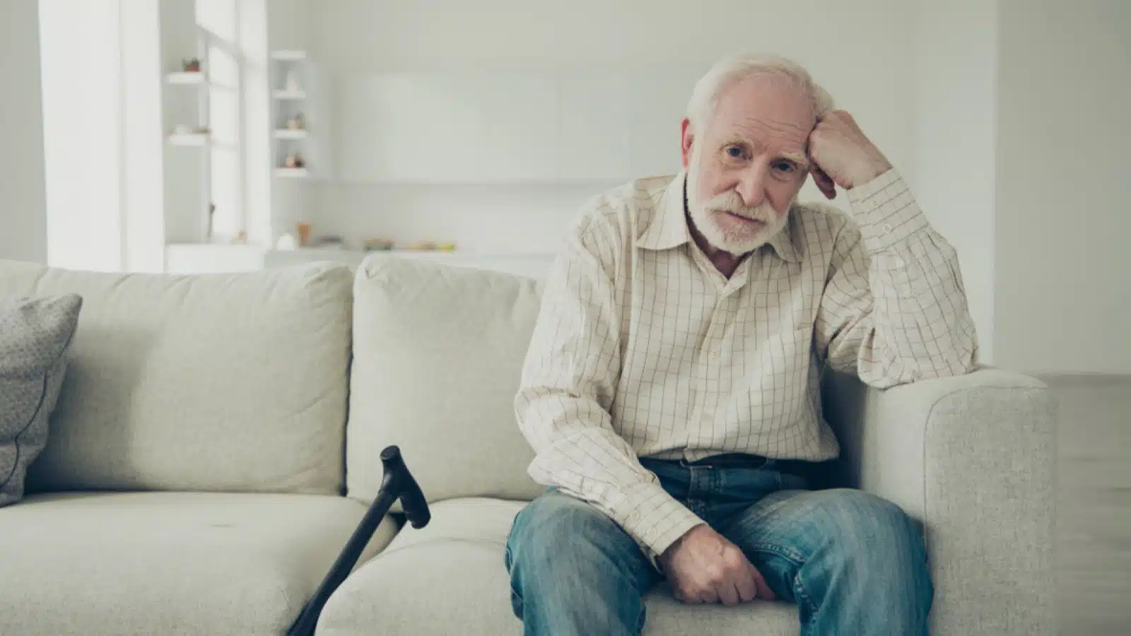 12 Things To Consider Before Moving Abroad After Retirement 18 Sad old man siting in sofa and thinking