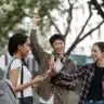 Happy college students with discounts shutterstock 2418368441